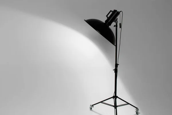 beauty dish studio flash mounted on a flash unit on a lighting workshop, turned on modelling light