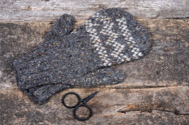 Gri el yapımı örgü eldivenler ve küçük makas. Önden Görünüm.