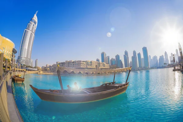 Dubai lagoon with boat against sunset in UAE — Stock Photo, Image