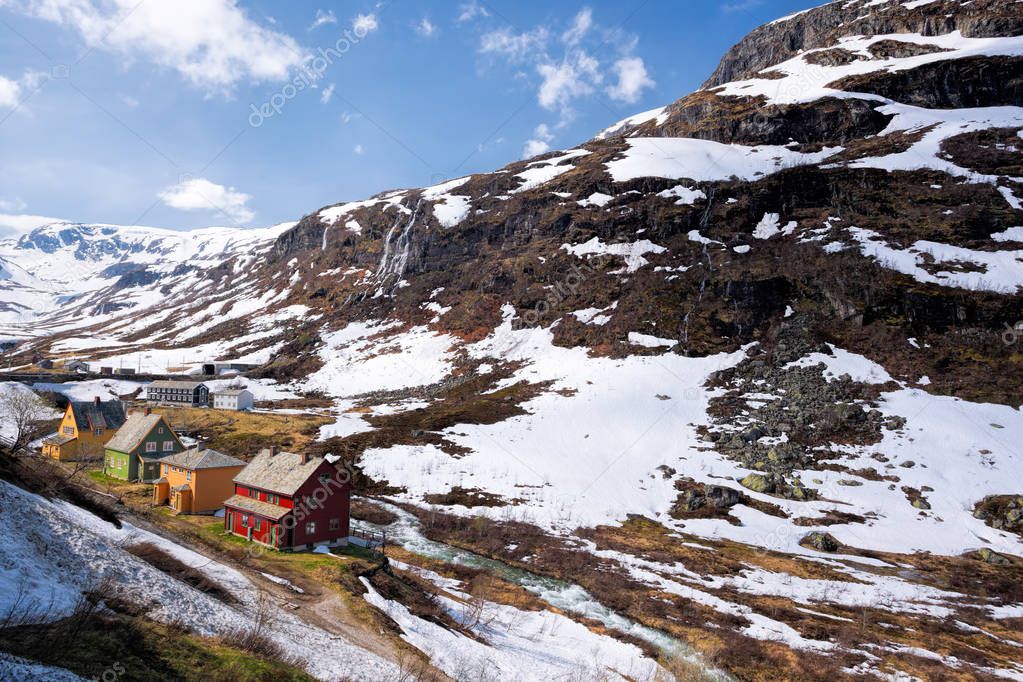 Norway with colorful wooden houses against waterfalls during spring time. Railroad from Flam to Myrdal in Norway