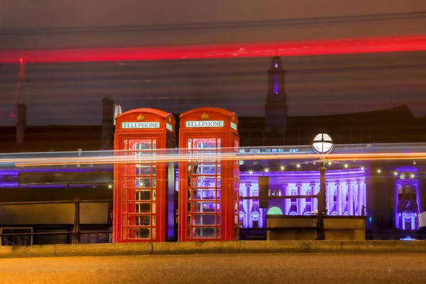 Red PHONE BOOTHS at night in London, England, UK