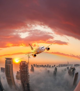 Uçak renkli günbatımı karşı Birleşik Arap Emirlikleri Dubai uçuyor