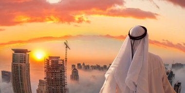 Arabian man is watching Dubai marina in Dubai, United Arab Emirates. clipart