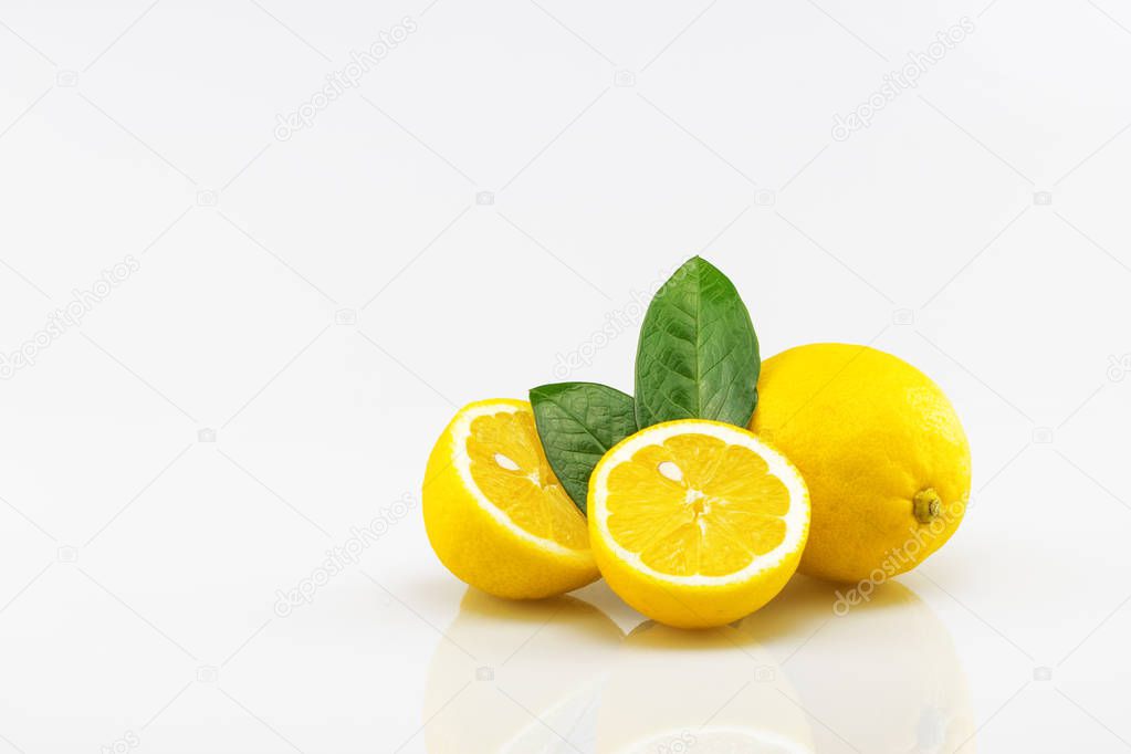 Fresh halved lemons with green leaf