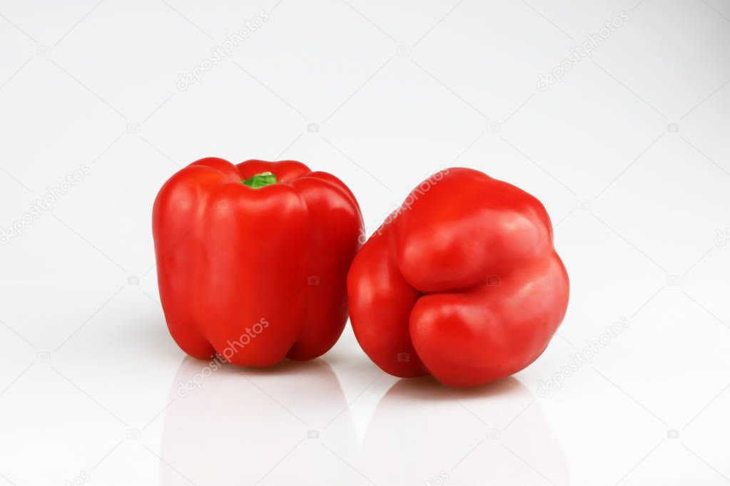 Two fresh red bell peppers