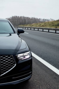 Headlight of a modern car. Black car 