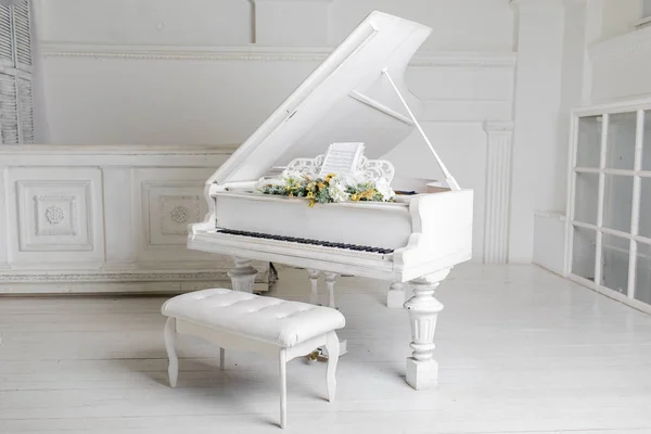 white piano in a white interior. Luxury interior.