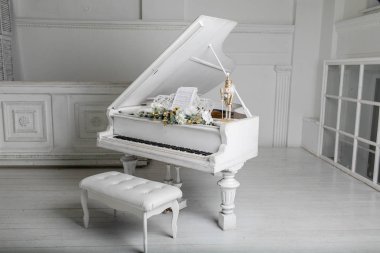 White piano in white room. play music. clipart