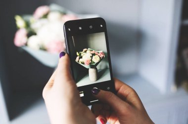 Blogcu bir buket çiçeğin fotoğrafını çekiyor