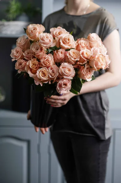 Bright pink spray roses in female hands — 스톡 사진