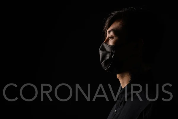 Asian man with medical face mask to protection the coronavirus. Young Asian man living in city with polluted air.