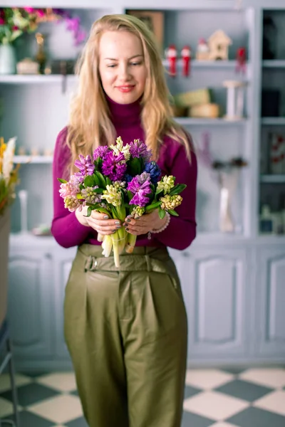 Florist holding a bouquet. Beautiful spring flowers. Arrangement with mix flowers. The concept of a flower shop, a small family business. Work florist. copy space