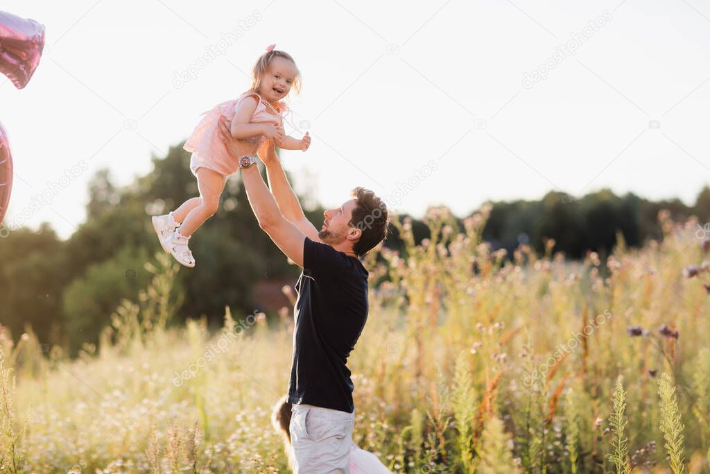 Fathers day. Happy family daughter hugs his dad on holiday