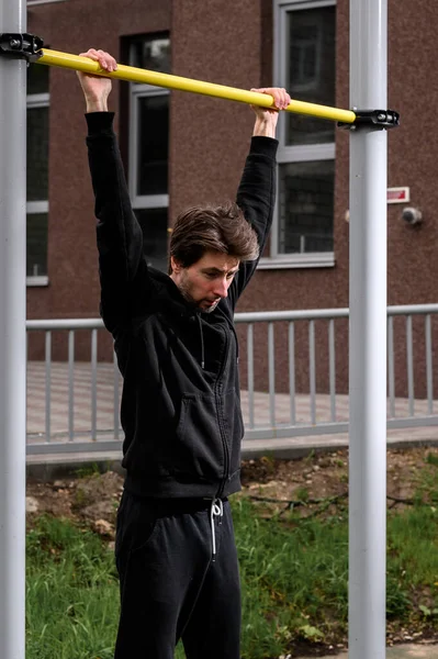 Atleet voert een oefening uit op de dwarsbalk — Stockfoto