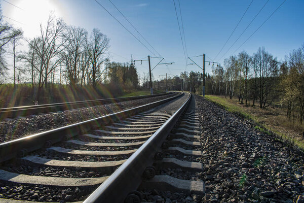 railroad leaving into the distance, against the blue sky