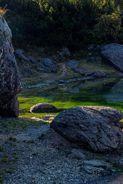 Rocks with green water of mountain lake at Seven lakes, Bohinj