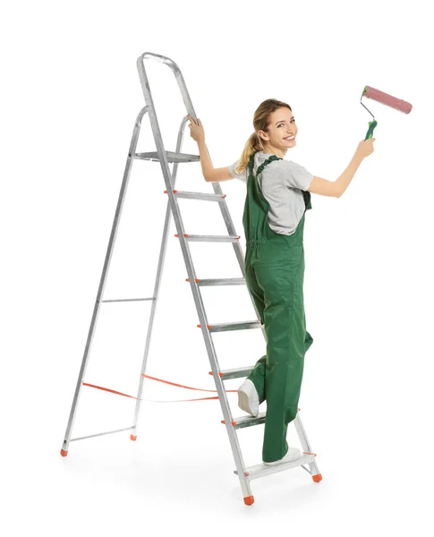 Young female decorator with paint roller on white background — Stock Photo, Image