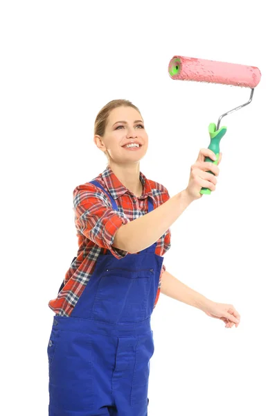 Young female decorator with paint roller on white background — Stock Photo, Image