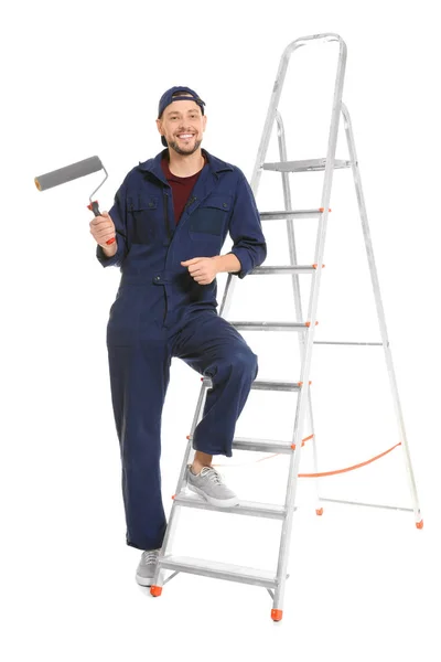 Young male decorator with paint roller on white background — Stock Photo, Image