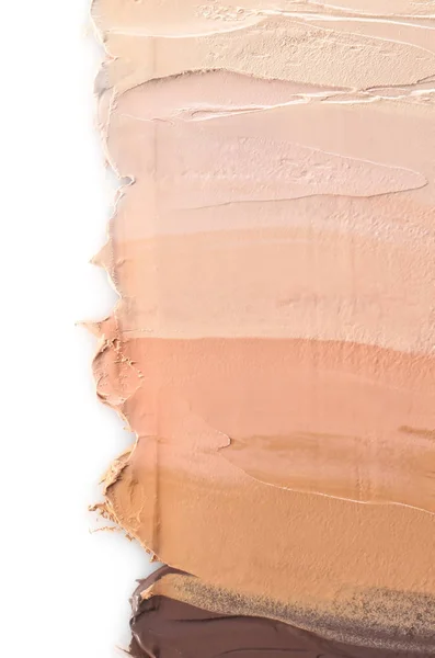 Different shades of foundation on white background. Professional makeup products
