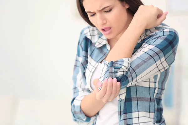 Young woman suffering from elbow pain  at home — Stock Photo, Image