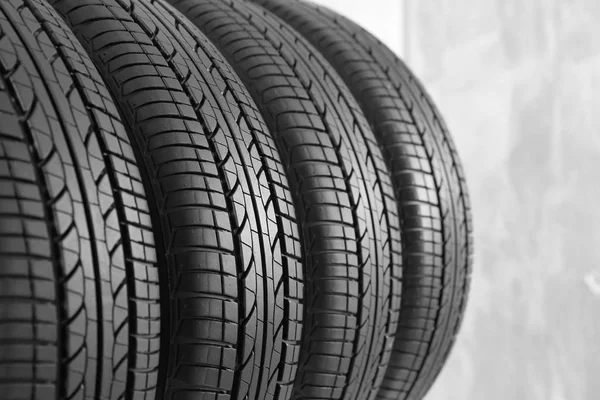 Neumáticos de coche sobre fondo gris, primer plano —  Fotos de Stock