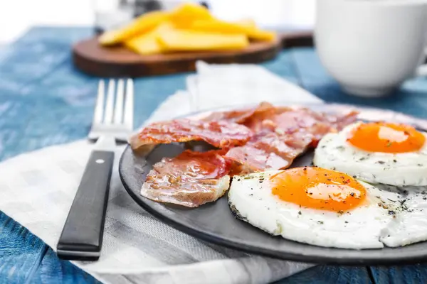 Sahanda yumurta ve domuz pastırması masada, closeup ile plaka — Stok fotoğraf