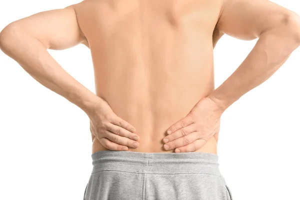 Young man suffering from back pain on white background — Stock Photo, Image