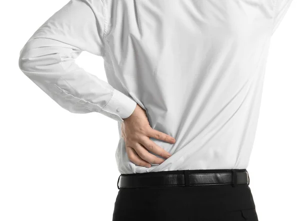 Young man suffering from back pain on white background — Stock Photo, Image