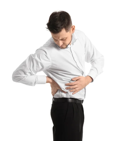 Fiatal férfi szenved hátfájás fehér háttér — Stock Fotó