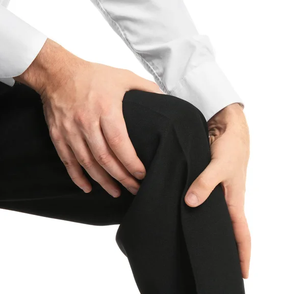 Young man suffering from knee pain on white background — Stock Photo, Image