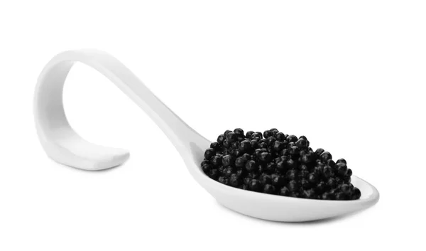 Colher de cerâmica com caviar preto sobre fundo branco — Fotografia de Stock