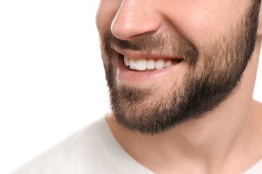 Beyaz arka plan üzerinde güzel gülümseme ile genç adam. Diş beyazlatma