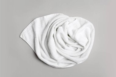 Yumuşak banyo havlusu gri arka planda, üstten görünüm