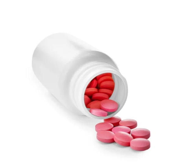 Kontejner s růžové pilulky na bílém pozadí — Stock fotografie