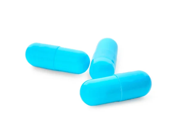 Capsules bleues sur fond blanc — Photo