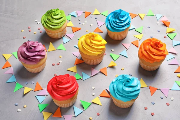 Deliciosos cupcakes de aniversário no fundo cinza — Fotografia de Stock