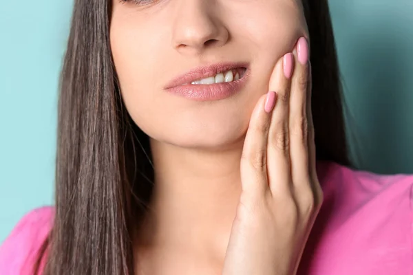 Mladá žena s citlivými zuby na barvu pozadí, closeup — Stock fotografie
