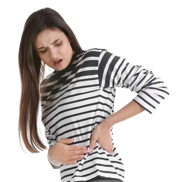 Junge Frau leidet unter Flankenschmerzen auf weißem Hintergrund — Stockfoto