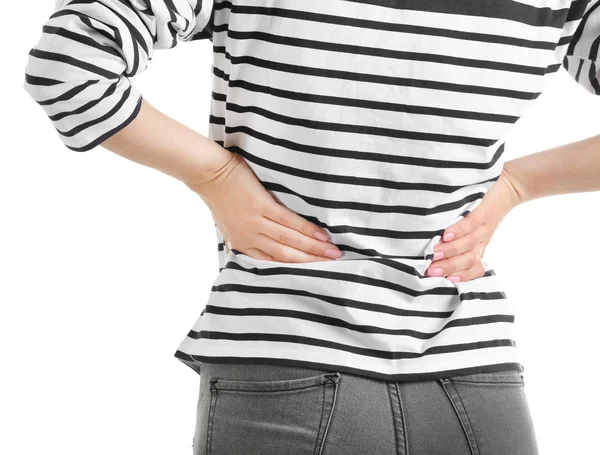 Young woman suffering from back pain on white background — Stock Photo, Image