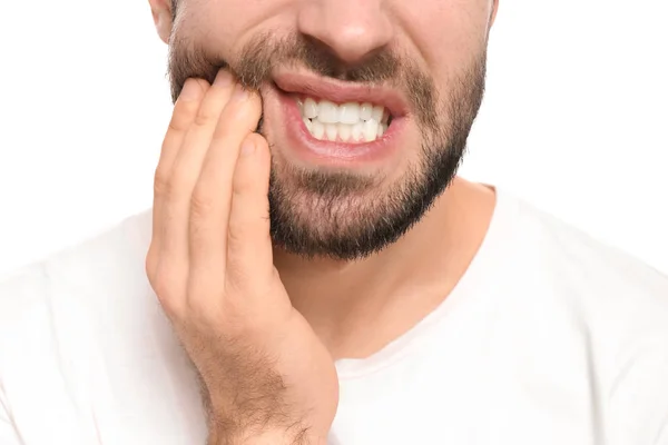 Young man suffering from toothache on white background — Stock Photo, Image