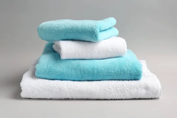 Soft bath towels on grey background — Stock Photo, Image