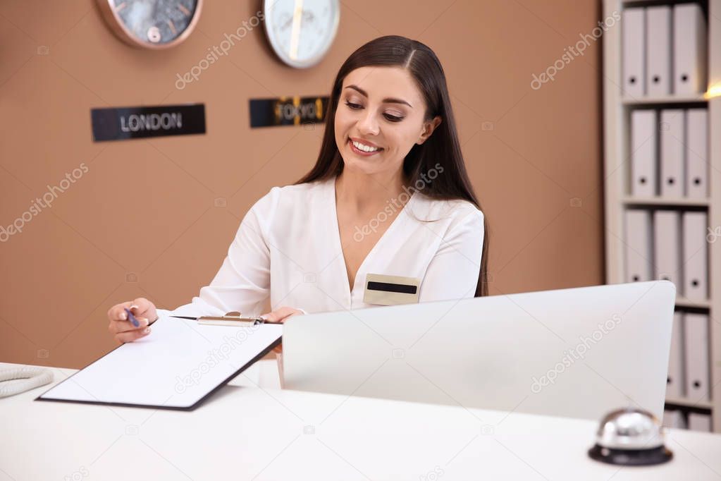 Female receptionist at hotel check-in counter