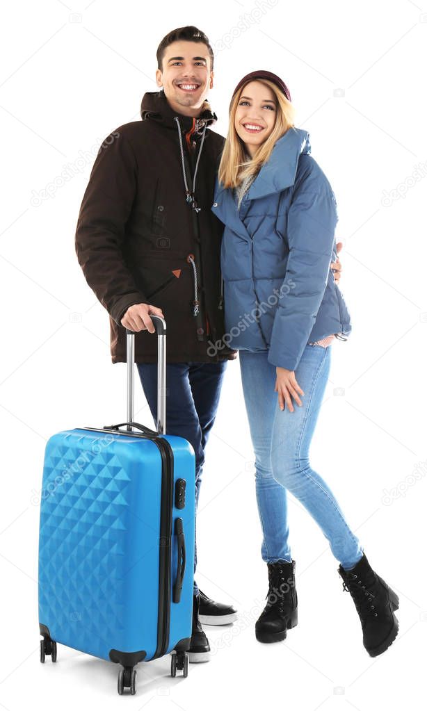 Young couple with suitcase on white background. Ready for winter vacation