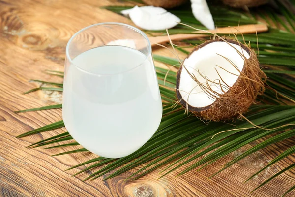 Glass of coconut water on wooden table — Stock Photo, Image