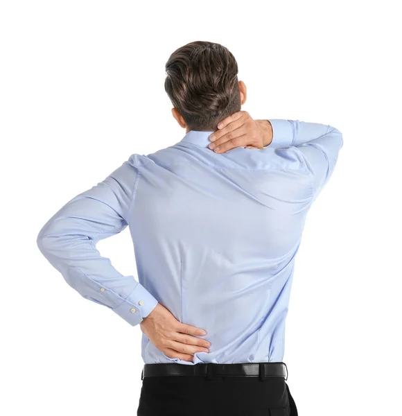 Junger Mann leidet unter Rückenschmerzen auf weißem Hintergrund — Stockfoto