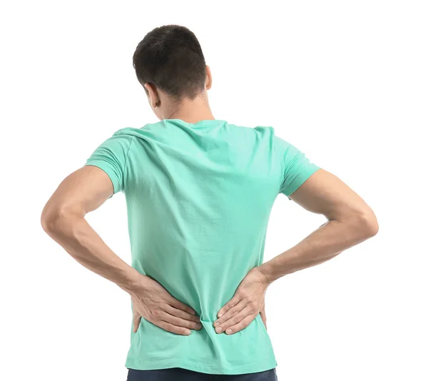 Un tânăr care suferă de dureri de spate pe fundal alb — Fotografie, imagine de stoc