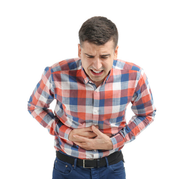 Young man suffering from abdominal pain on white background