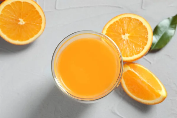 Glass of orange juice and fresh fruits on table, top view — Stock Photo, Image