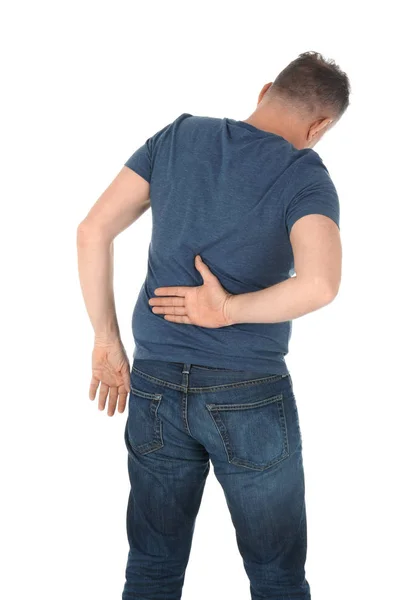 Homem que sofre de dor nas costas no fundo branco — Fotografia de Stock